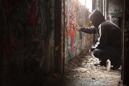graffiti artist spraying a wall
