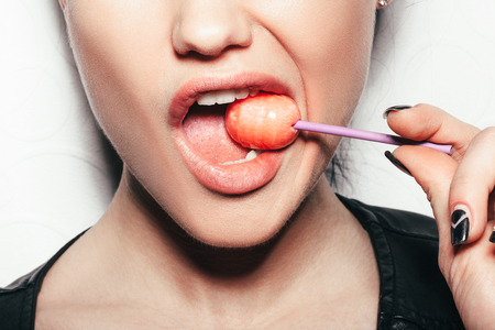 licking a lollipop